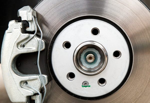 New car brakes. Car brake system closeup. Brake support and disk close-up view.