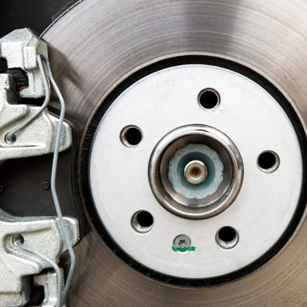 New car brakes. Car brake system closeup. Brake support and disk close-up view.